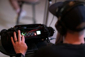 BYU College of Fine Arts student works with equipment behind the scenes of Arts and Comms: Behind the Stories