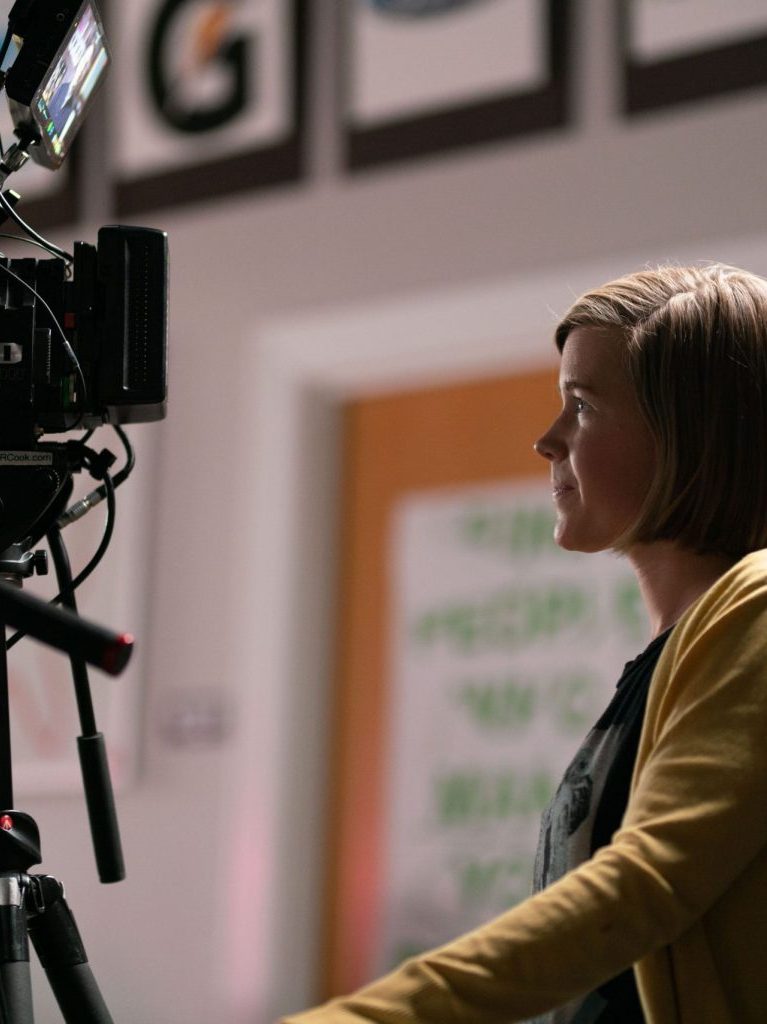 girl behind filming equipment