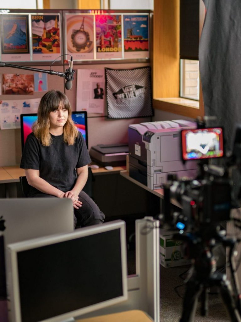 girl by her desk being interviewed